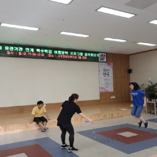 음악줄넘기에 참여한 학생들이 강사와 함께 긴줄넘기를 활용하여 줄넘기를 하고 있는 모습